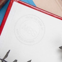 Example of custom Initial Embosser impression on the inside of a book