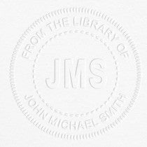 Example of From the Library Initials Personalized Book Embosser Imprint on grey paper