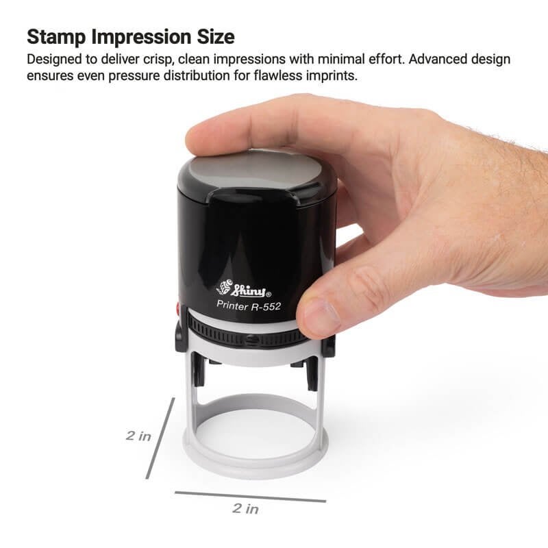 A hand presses the Shiny R-552 stamp, highlighting its round 2" x 2" impression area