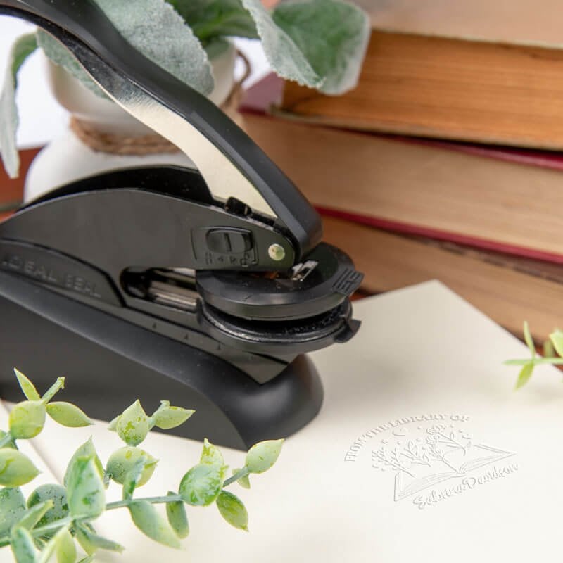 Personalized book embosser lifestyle image with stamp impression
