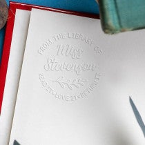 Round Script Name Floral Branch From the Library Of Custom Book Embosser Impression on Book