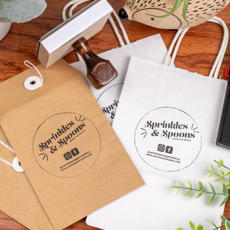Example of a 3" by 3" Hand Stamp on brown and white paper. 