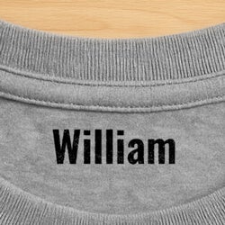 a first and last name stamp impression on a gray shirt